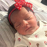 Miah Julieta joined the competition — help win amazing prizes! baby, newborn, sleeping, headband, red, white, hearts, clothing, squirrel, floral_pattern, infant, cute, peaceful, portrait, closeup, soft_light, bed, blanket, resting, child