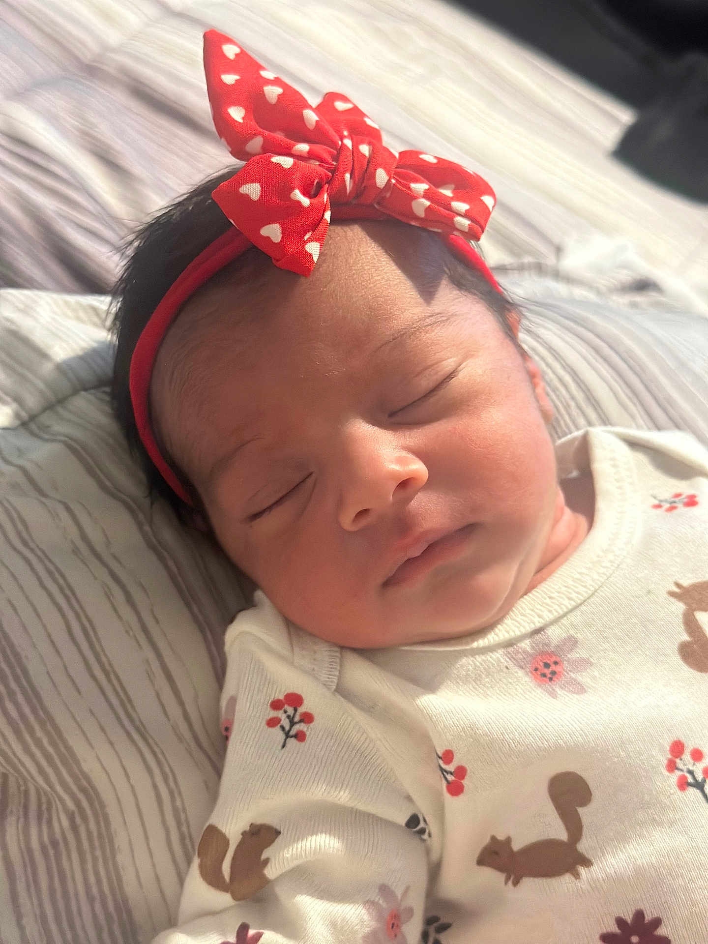 Miah Julieta joined the competition — help win amazing prizes! baby, newborn, sleeping, headband, red, white, hearts, clothing, squirrel, floral_pattern, infant, cute, peaceful, portrait, closeup, soft_light, bed, blanket, resting, child