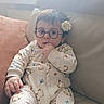 Elyass a rejoint le concours — aidez-le/la à gagner de superbes lots ! baby, glasses, flower, onesie, couch, indoor, child, curious, hand, finger, hair_clip, window, natural_light, patterned_clothing, seated, soft_light, cute, infant, face, portrait