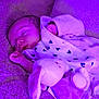 baby, sleeping, blanket, plush_toy, bunny, purple_light, cozy, infant, soft_texture, cute, peaceful, child, wrapped, resting, indoor, warm, toddler, face, person, comfort
