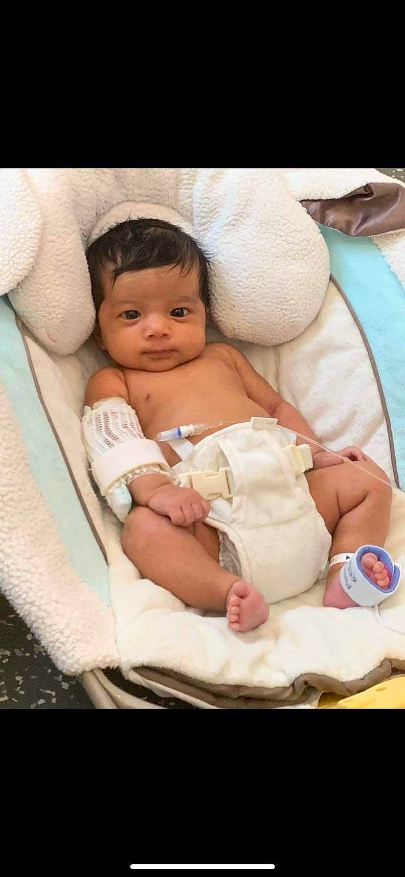 Calie joined the competition — help win amazing prizes! abdomen, baby, baby_products, baby_safety, baby_sleeping, baby_toddler_clothing, cheek, child, comfort, diaper, event, eye, finger, infant_bed, linens, person, pink, sitting, skin, thumb