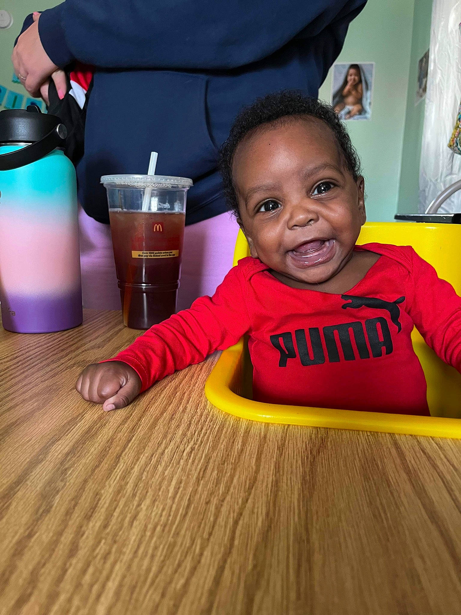 Angelo joined the competition — help win amazing prizes! baby, baby_toddler_clothing, blurred, child, cup, curtain, drink, drinking, drinkware, flooring, fun, happy, hardwood, person, plastic_bottle, skin, smile, toddler, varnish, water_bottle