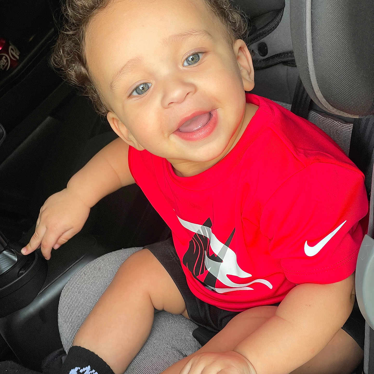 Rylan joined the competition — help win amazing prizes! baby, babylaughing, bodypart, clothing, cushion, face, footwear, happy, head, homedecor, laughing, mouth, person, photography, portrait, shoe, shorts, sitting, t_shirt, teeth