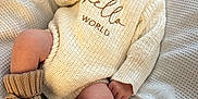 Oaklynn is registered to the contest to win money with this photo: baby, sleeping, knit_hat, knit_booties, knit_sweater, blanket, infant, cozy, cute, soft_texture, pom_pom, resting, newborn, warm_clothing, indoors, child, peaceful, small_hands, small_feet, portrait