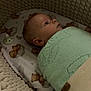 baby, infant, blanket, bedding, bassinet, knitted, teddy_bear, sleeping_area, cozy, soft_texture, child, portrait, indoors, cute, resting, wrapped, peaceful, newborn, face, sleeping_baby