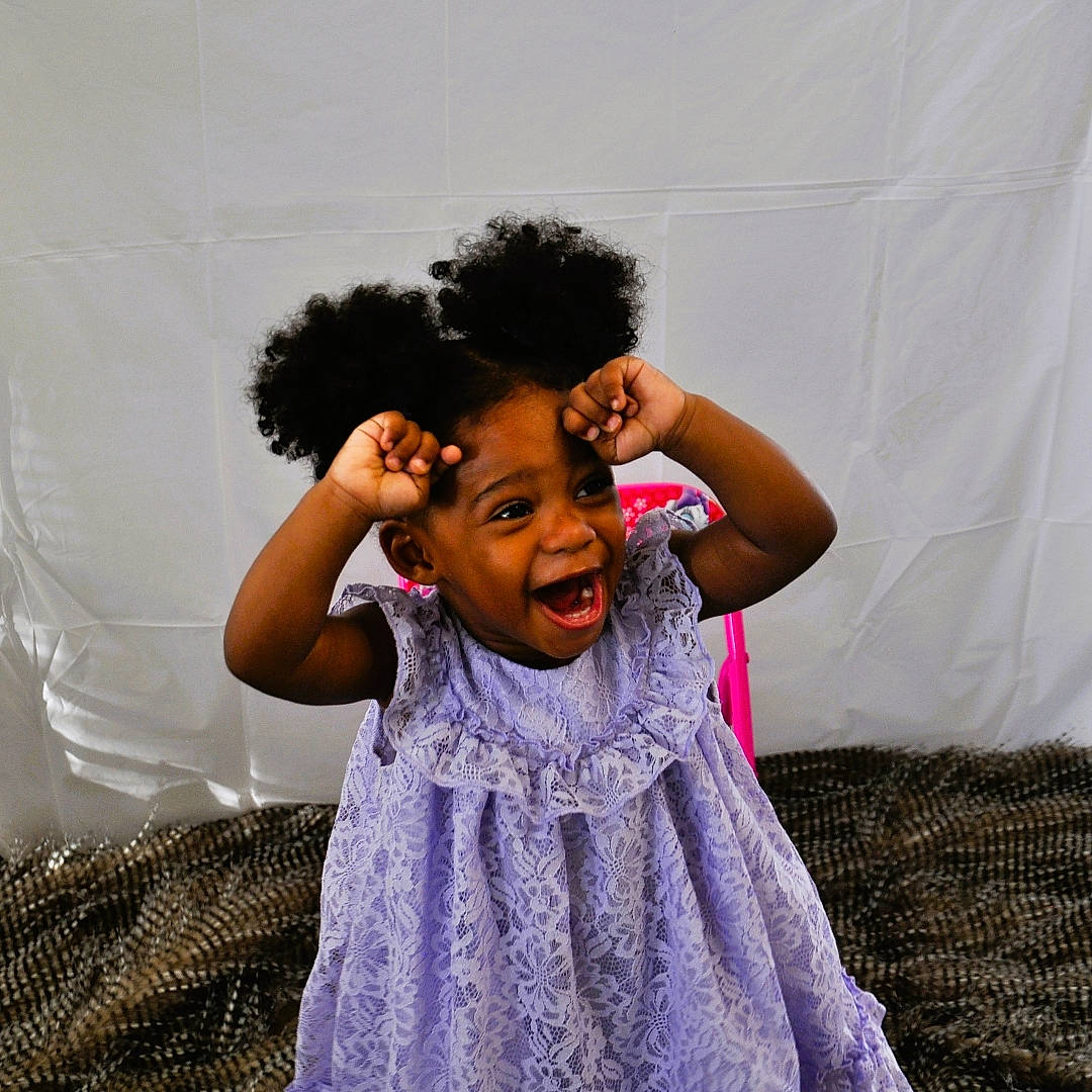 Leneah is registered to the contest to win money with this photo: arm, baby_toddler_clothing, black_hair, child, comfort, event, fashion_design, flash_photography, fun, gesture, happy, leisure, linens, magenta, performing_arts, person, purple, room, smile, toddler