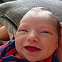 Santonio joined the competition — help win amazing prizes! baby, smiling, infant, close_up, striped_clothing, football_graphic, cushion, blanket, indoor, happy, face, head, person, newborn, toddler, soft_lighting, portrait, young_child, cozy, casual