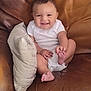 Myles is registered to the contest to win money with this photo: baby, child, comfort, couch, cozy, cute, expression, face, foot, hand, happy, indoor, infant, leather, onesie, pillow, playful, sitting, skin, smile
