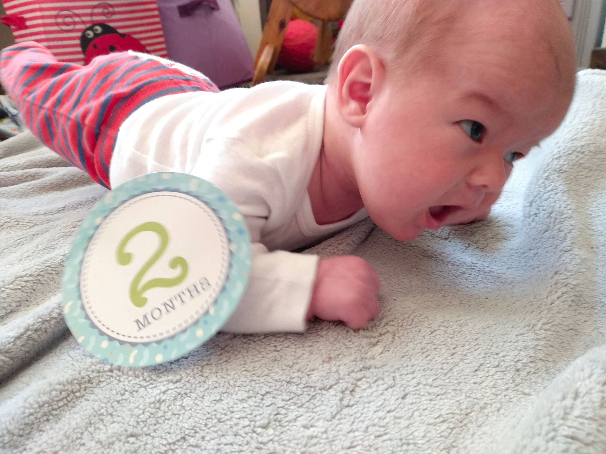 Owen is registered to the contest to win money with this photo: baby, baby_products, baby_toddler_clothing, cheek, comfort, drinkware, finger, flooring, fun, hand, happy, head, person, product, sitting, skin, sleeve, surprise, thumb, toddler