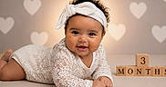 Lailani Jackson is registered to the contest to win money with this photo: adorable, baby, celebration, child, closeup, crawling, cute, happy, headband, heart_pattern, infant, lace, milestone, portrait, smiling, soft_lighting, studio, tummy_time, wooden_blocks, young