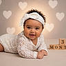 adorable, baby, celebration, child, closeup, crawling, cute, happy, headband, heart_pattern, infant, lace, milestone, portrait, smiling, soft_lighting, studio, tummy_time, wooden_blocks, young