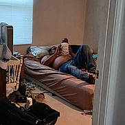 Deonte is registered to the contest to win money with this photo: man, baby, bed, room, window, blinds, pillow, jeans, shirtless, carseat, hat, floor, clutter, door, blanket, cradle, casual, indoor, parenting, relaxing