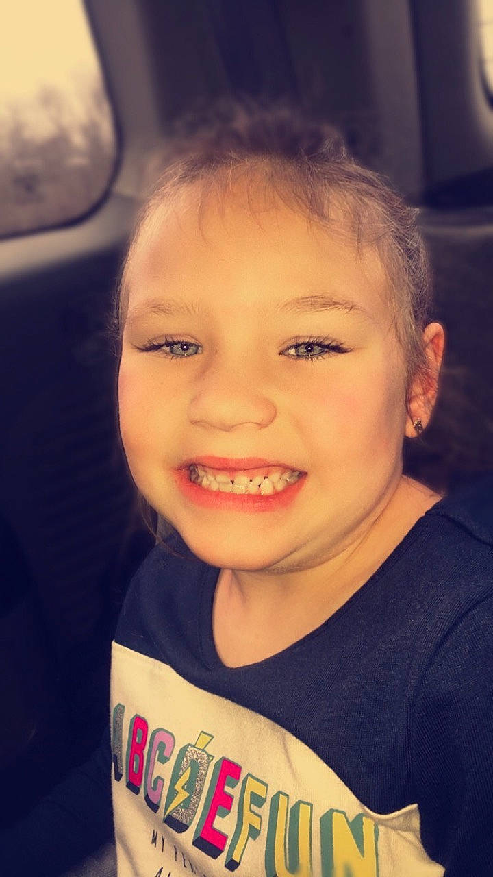 Molly is registered to the contest to win money with this photo: cheek, child, chin, cool, eyebrow, face, facial_expression, forehead, hair, hairstyle, head, joy, lip, nose, organ, people, person, skin, sky, smile