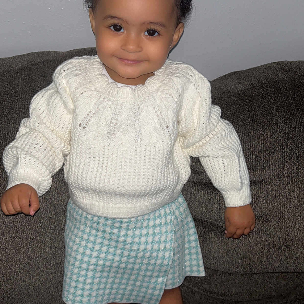 Priseis joined the competition — help win amazing prizes! blue_skirt, child, couch, cozy, curly_hair, cute, face, fashion, happy, indoors, knitted, person, portrait, smiling, socks, standing, toddler, white_socks, white_sweater, young_child