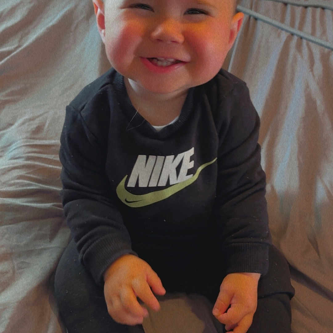 Harrison Jr joined the competition — help win amazing prizes! bed, casual, child, clothing, cute, face, footwear, hair, hands, happy, indoors, nike, pants, person, room, sitting, smiling, sneakers, sweatshirt, toddler
