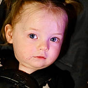 Olivia is registered to the contest to win money with this photo: baby, black_clothing, blue_eyes, car_seat, child, closeup, expression, face, hair, indoor, infant, looking_away, portrait, seat_harness, seatbelt, skin, stars, toddler, warning_label, young_child