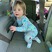 Olivia joined the competition — help win amazing prizes! toddler, child, pajamas, car_interior, seat, seatbelt, water_bottle, can, floor, curious, blue_eyes, blond_hair, clothing, person, indoor, daylight, vehicle, crouching, car_seat, window