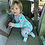 toddler, child, pajamas, car_interior, seat, seatbelt, water_bottle, can, floor, curious, blue_eyes, blond_hair, clothing, person, indoor, daylight, vehicle, crouching, car_seat, window