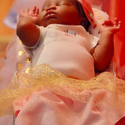 Da?niyah is registered to the contest to win money with this photo: cake_decorating, child, close_up, finger, fondant, girl, hand, infant, lip, mouth, petal, pink, skin, sweetness