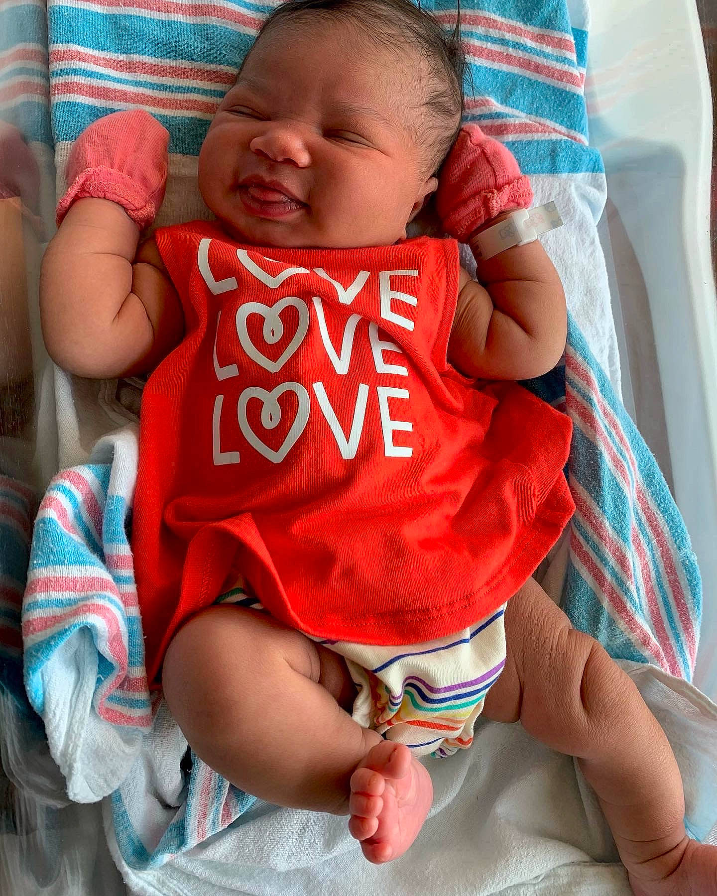 Journee is registered to the contest to win money with this photo: baby, baby_toddler_clothing, cheek, comfort, eye, facial_expression, finger, green, happy, head, mouth, nail, organ, person, red, skin, sleeve, smile, thigh, thumb