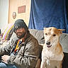 Baby Girl joined the competition — help win amazing prizes! man, dog, couch, indoor, beanie, glasses, beard, wood_panel_wall, blanket, decor, smiling_dog, casual_clothing, seated, friendly, pet, relaxed, home, furniture, portrait, happy