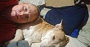 Baby Girl is registered to the contest to win money with this photo: person, dog, bed, pillow, indoor, relaxing, lying_down, casual, comfort, animal, pet, resting, human, brown, tan, white, face, sleepy, cozy, blanket