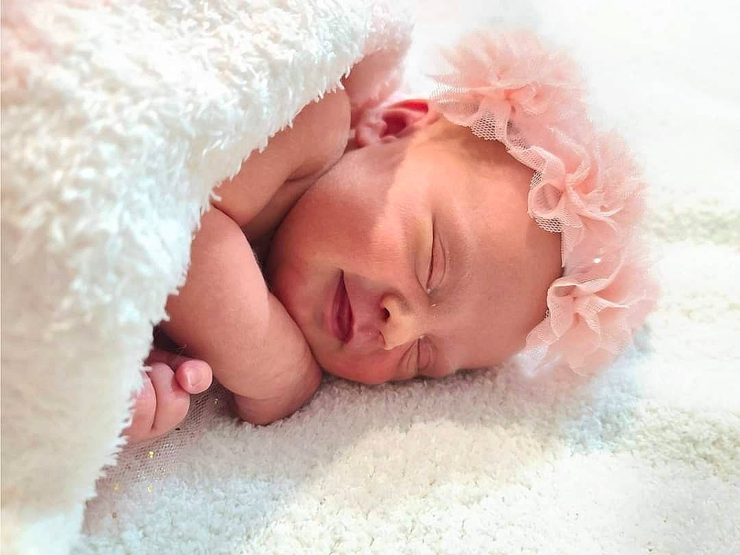 Reese is registered to the contest to win money with this photo: baby, baby_sleeping, bed, bed_sheet, bedding, bedtime, child, comfort, eye, fashion_accessory, fur, hair_accessory, happy, head, linens, nap, person, portrait_photography, room, sleep