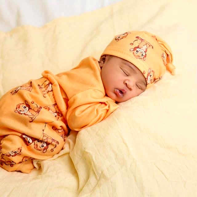 Quintavious joined the competition — help win amazing prizes! baby, bed, bedding, blanket, cartoon_pattern, cute, eyes_closed, face, hat, indoors, infant, newborn, orange_clothing, pajamas, peaceful, photography, portrait, resting, sleeping, soft_lighting