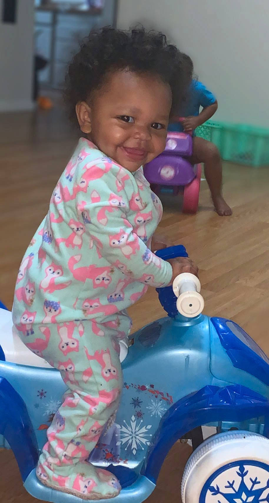 Kimora joined the competition — help win amazing prizes! baby, baby_toddler_clothing, blue, cheek, fun, happy, joy, mammal, motor_vehicle, organ, person, photograph, pink, product, riding_toy, skin, smile, standing, toddler, wheel
