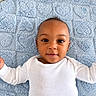 baby, infant, child, portrait, lying_down, smiling, face, eyes, white_outfit, long_sleeves, blue_blanket, blanket, indoor, close_up, adorable, happy, looking_at_camera, arms_outstretched, baby_bedding, photography