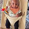 baby, infant, child, high_chair, sitting, portrait, face, eyes, curious, hand, rainbow_toy, toy, bib, scarf, shirt, pants, socks, indoor, carpet, furniture