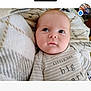 Jace joined the competition — help win amazing prizes! baby, infant, face, blanket, clothing, portrait, child, cute, lying_down, soft_texture, striped, young, skin, head, eyes, expression, cozy, indoors, comfortable, babywear