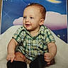 baby, blanket, child, clothing, clouds, eyes, face, hair, happy, indoor, infant, moon, night_sky, photograph, plaid_shirt, portrait, sitting, smiling, socks, soft_surface