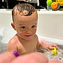 toddler, child, bath, bathtub, bubbles, wet_hair, toy, yellow_toy, purple_toy, foam, water, skin, playful, cute, smile, indoor, baby, young_child, fun, happy