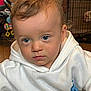 Sonny joined the competition — help win amazing prizes! toddler, child, blue_eyes, curly_hair, hoodie, white_clothing, indoor, portrait, face, baby, young_child, expression, sitting, person, cute, soft_lighting, looking_down, serious, close_up, skin