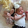 baby, sleeping, plush_toy, headband, flower, blanket, soft_toy, pampas_grass, infant, cute, child, white_top, floral_skirt, resting, cozy, indoor, peaceful, adorable, skin, person