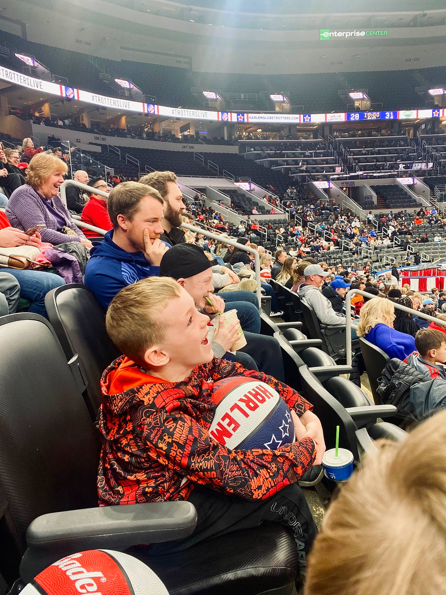 Reece is registered to the contest to win money with this photo: arena, audience, automotive_tire, championship, competition_event, crowd, event, fan, fun, games, gesture, hat, headwear, joy, person, player, public_event, racing, sport_venue, sports