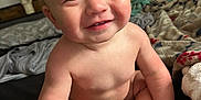 Karson joined the competition — help win amazing prizes! baby, child, smiling, face, hair, mohawk, skin, hand, foot, bed, blanket, diaper, indoor, person, cute, happy, infant, expression, young, sitting