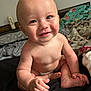 baby, child, smiling, face, hair, mohawk, skin, hand, foot, bed, blanket, diaper, indoor, person, cute, happy, infant, expression, young, sitting