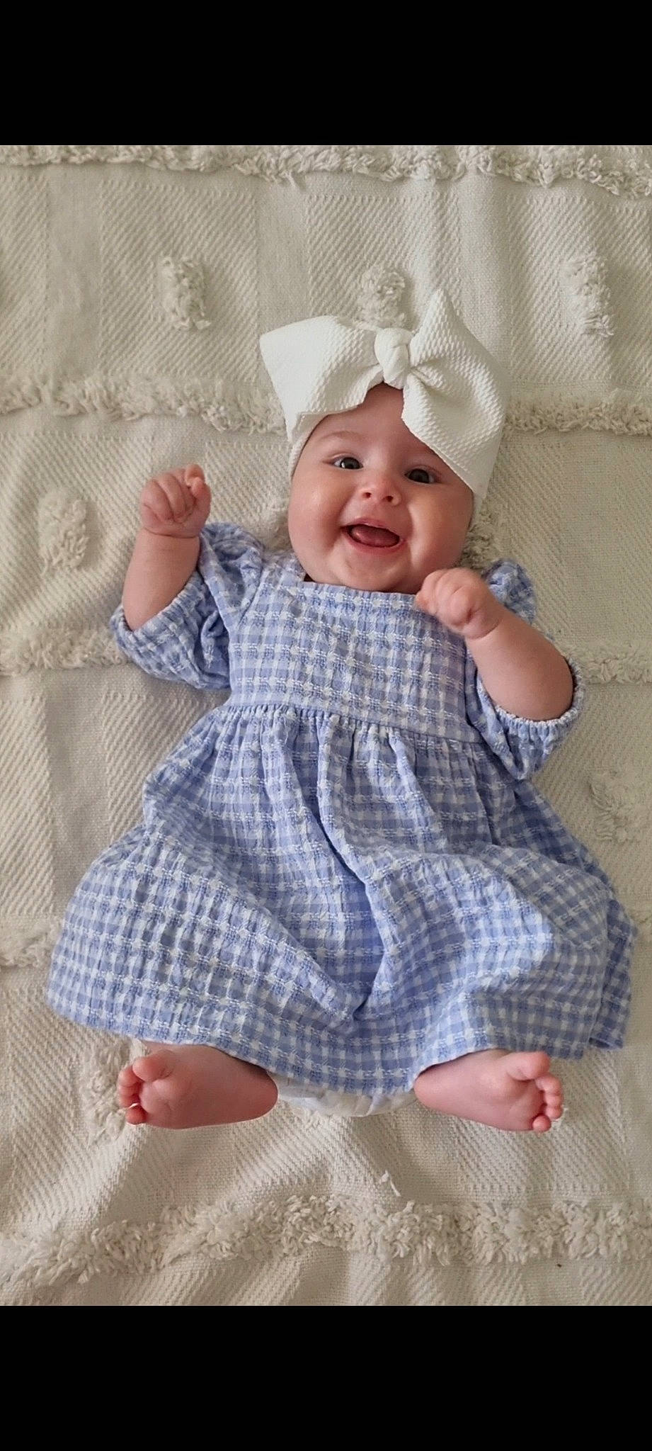 Charlee is registered to the contest to win money with this photo: baby, baby_toddler_clothing, child, comfort, facial_expression, flooring, happy, headwear, linens, pattern, person, pink, plaid, product, sitting, skin, sleeve, smile, t_shirt, textile