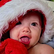 Amani is registered to the contest to win money with this photo: baby, cheerful, child, closeup, cute, expression, face, festive, fur, holiday, infant, portrait, red, santa_hat, skin, smiling, soft_texture, tongue, warm, white