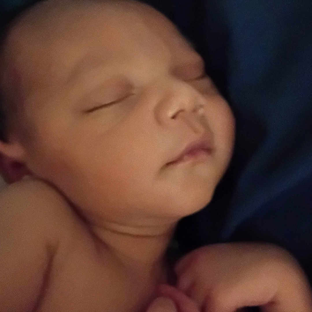 Raheem joined the competition — help win amazing prizes! arms, baby, bed, blanket, close_up, closed_eyes, cozy, curled_up, date_stamp, dim_lighting, face, hands, indoors, infant, newborn, peaceful, portrait, resting, skin, sleeping