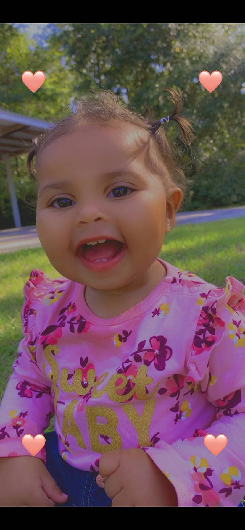 Aliyah is registered to the contest to win money with this photo: baby, cheek, child, eye, face, facial_expression, forehead, grass, happy, head, iris, lip, mouth, nose, person, pink, plant, skin, smile, summer
