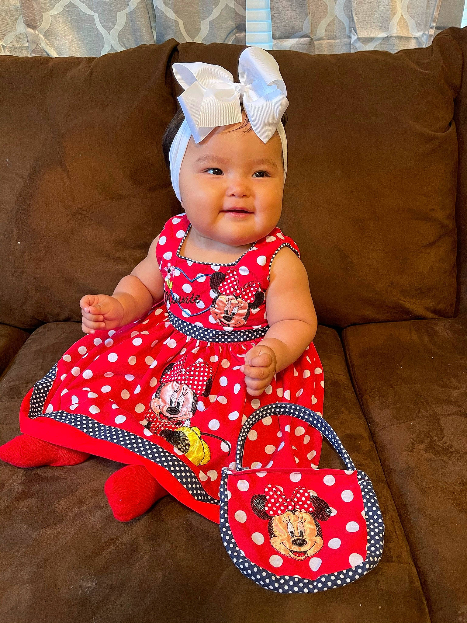 Kali is registered to the contest to win money with this photo: baby, baby_toddler_clothing, child, clothing, comfort, day_dress, dress, happy, hat, headwear, magenta, one_piece_garment, pattern, person, pink, sitting, skin, sleeve, smile, textile