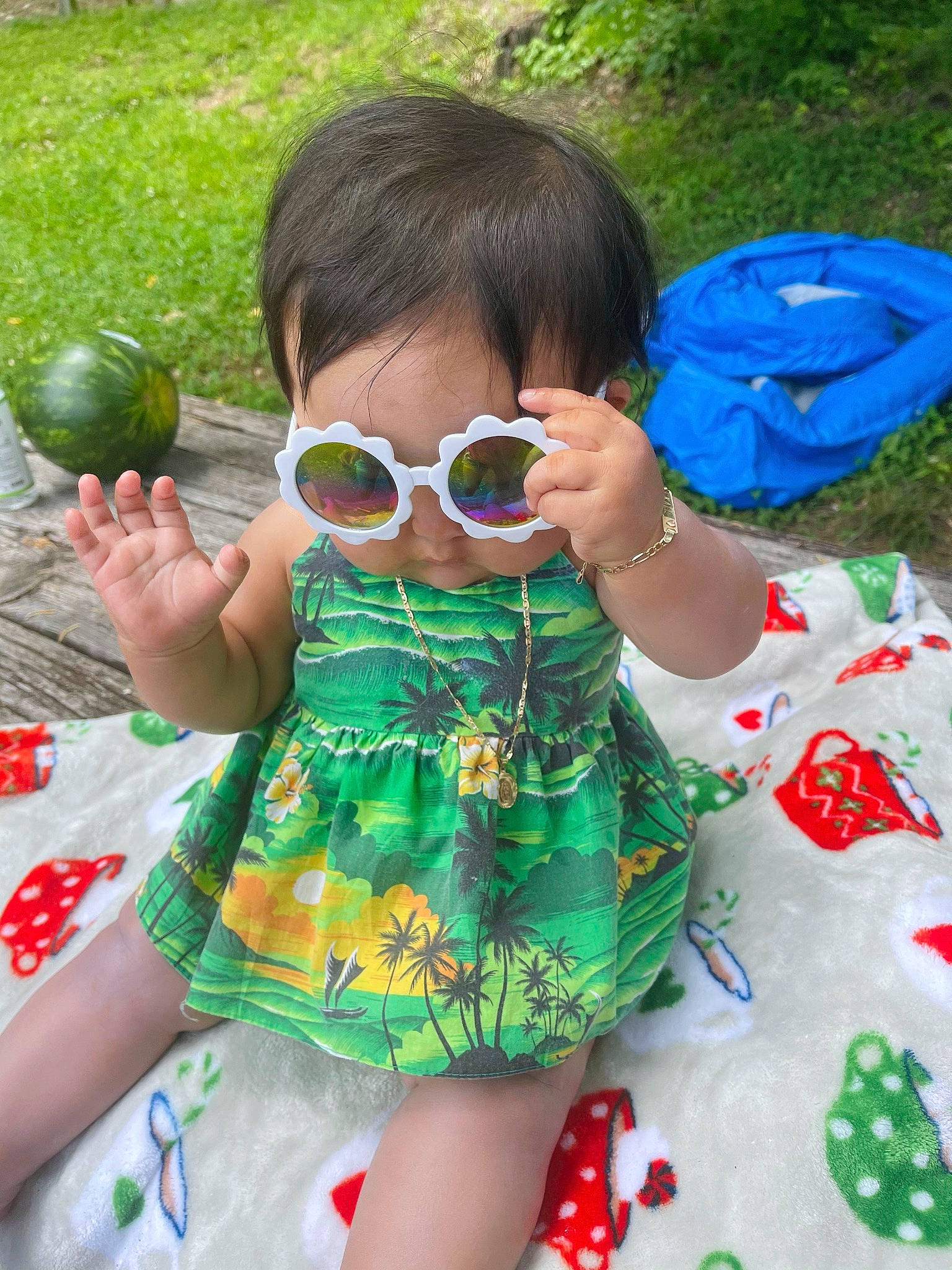 Kali is registered to the contest to win money with this photo: baby_toddler_clothing, ball, botany, child, eyewear, finger, fun, goggles, grass, green, leaf, pattern, person, plant, sleeve, summer, sunglasses, tableware, terrestrial_plant, thumb
