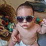 baby, basket, casual, child, colorful, cute, diaper, drool, expression, floor, indoor, infant, person, play_area, plush_toy, portrait, stuffed_animal, sunglasses, toy, wooden_floor