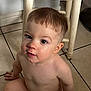Lucian is registered to the contest to win money with this photo: toddler, child, face, skin, hair, floor, tile, chair, indoor, looking_up, curious, expression, young_child, scab, casual, naked, human, portrait, candid, home