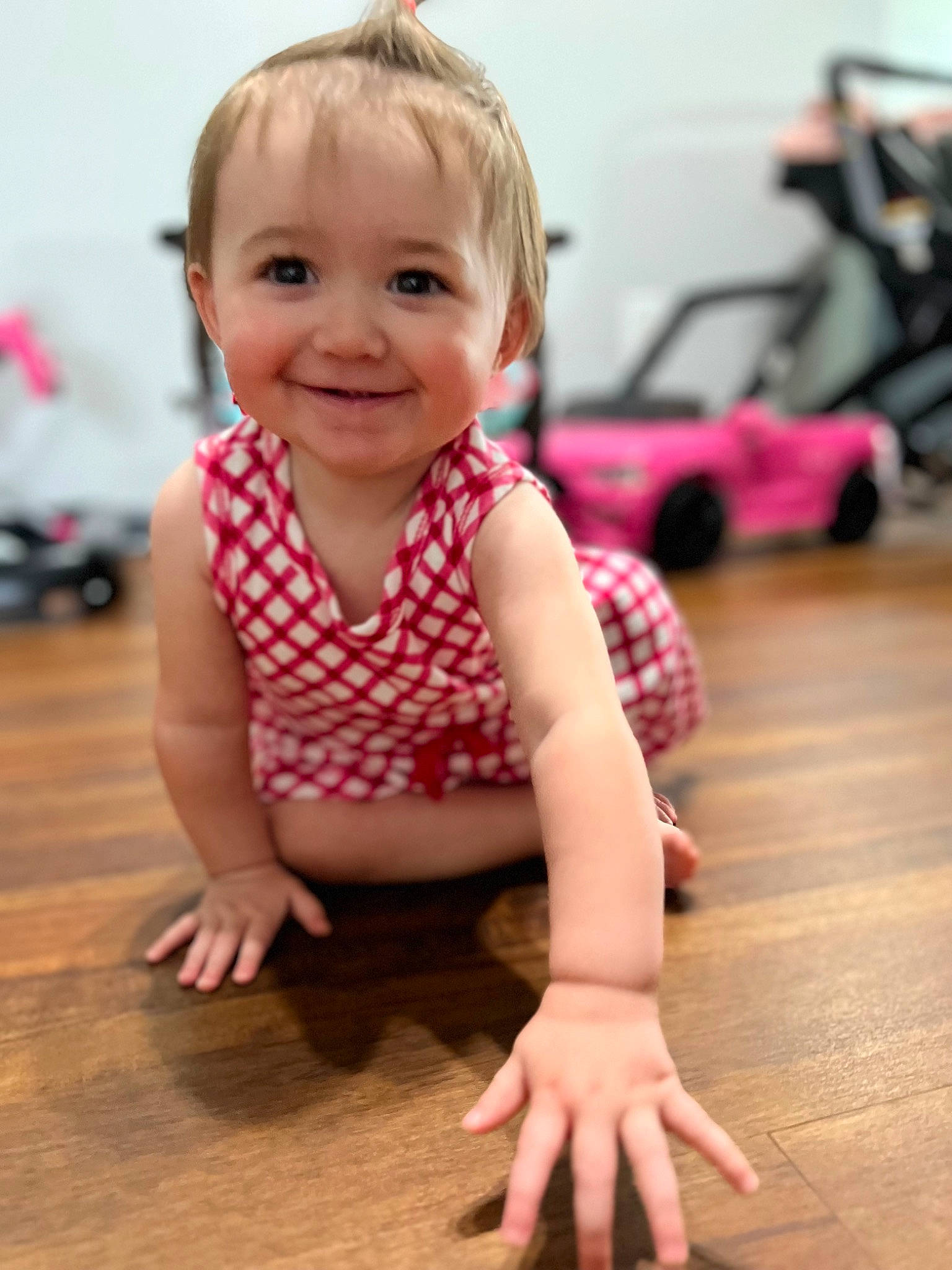 Mason is registered to the contest to win money with this photo: baby, baby_toddler_clothing, cheek, child, floor, flooring, fun, happy, hardwood, human_leg, joy, pattern, person, pink, skin, sleeve, smile, thumb, tire, toddler