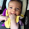 Eris is registered to the contest to win money with this photo: baby, infant, child, car_seat, purple_bow, yellow_cloth, hand, smile, face, blue_eyes, clothing, seat_belt, happy, cute, portrait, indoor, person, skin, headband, baby_accessory