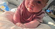 Eris is registered to the contest to win money with this photo: baby, infant, child, blanket, face, eyes, hair, pout, soft_lighting, bedroom, cozy, curious, lying_down, close_up, skin, clothing, person, indoors, toddler, expression